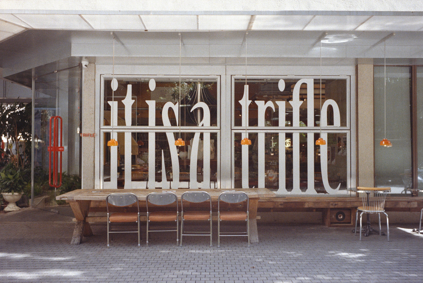Window Light: supplied positive conversion showing chairs in front of lettered glass windows.